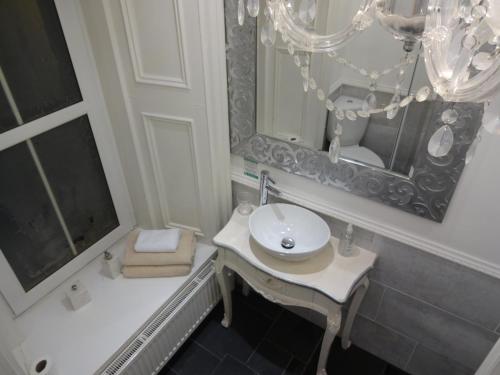a bathroom with a white sink and a mirror at Lochnagar Guest House in Aberdeen