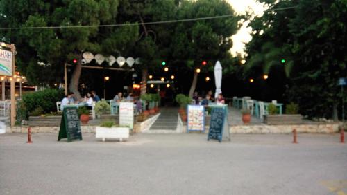 a group of signs in a park at night at Villa George - Family Holidays in Nea Makri
