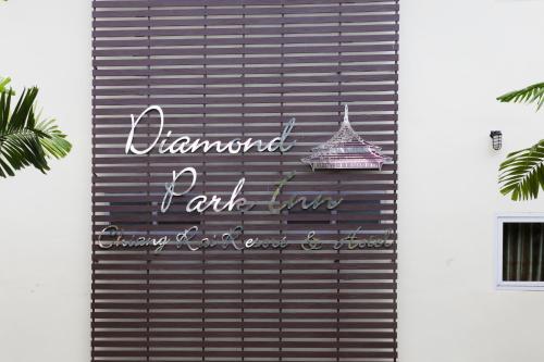a sign on the side of a building at Diamond Park Inn Chiangrai & Resort in Chiang Rai