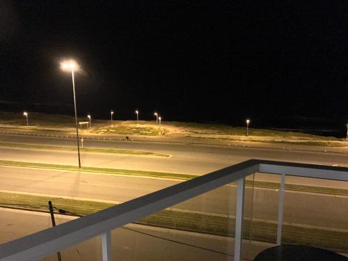 an empty street at night with street lights at Marco Polo Platinum Apartamento in Mar del Plata