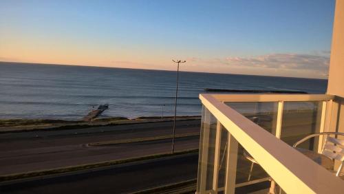 a view of the ocean from the balcony of a building at Marco Polo Platinum Apartamento in Mar del Plata