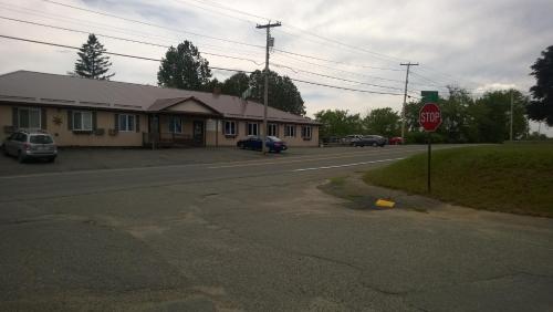 a street scene with cars parked on the side of the road at Hotel Terrace in Millinocket