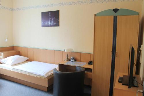 Ένα ή περισσότερα κρεβάτια σε δωμάτιο στο TM Hotel Essen