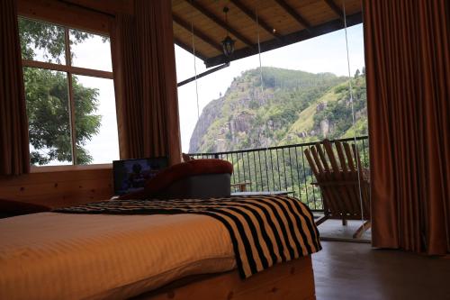 a bedroom with a bed and a view of a mountain at Country Homes in Ella