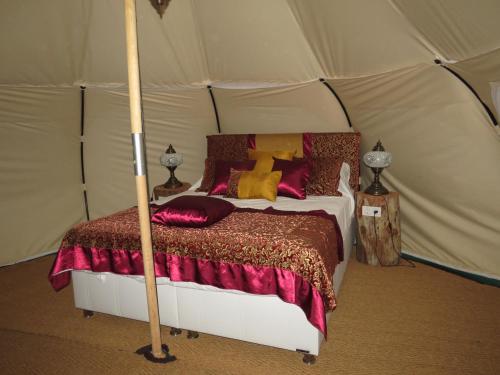 a bedroom with a bed in a tent at Azure Wellness Retreat in Turgutreis