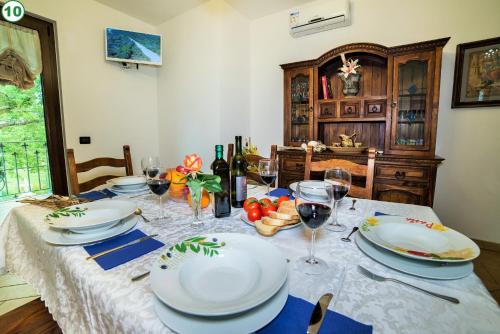 a dining room table with plates and glasses of wine at I Gigli del Belvedere in Montefiascone