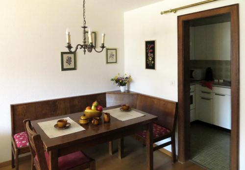 a dining room with a table with fruit on it at Holiday accommodation - swimming pool available in Davos