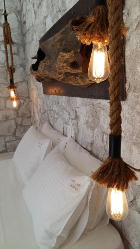 a room with a bed with lights on it at Milo Milo Suites in Mandrakia
