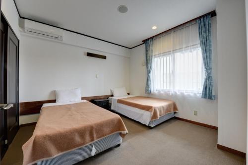 מיטה או מיטות בחדר ב-Beach Resort Morimar