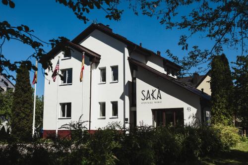 a white building with the words skka on it at SAKÀ Vacation House in Druskininkai