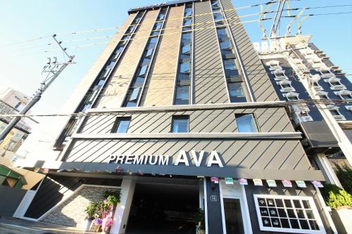 a large building with a sign on the side of it at Premium Ava Hotel in Busan