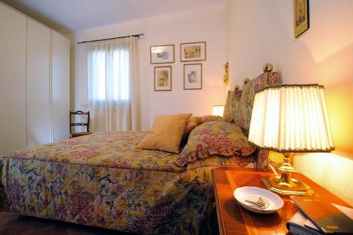 a bedroom with a bed and a table with a lamp at Agriturismo - B&B L'Acquacotta in Castiglione della Pescaia
