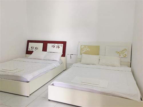 Ένα ή περισσότερα κρεβάτια σε δωμάτιο στο Chi Hieu Hotel