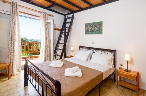 a bedroom with a bed and a balcony at Romanza Villas in Sitia