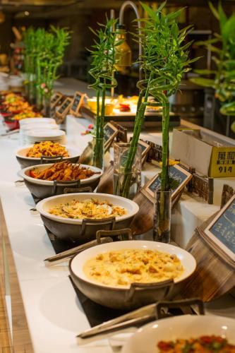 a buffet with many plates of food on a table at Soluxe Hotel Guangzhou - Overseas Buyers Registration Service&Canton Fair Free Shuttle Bus 15 Oct to 04 Nov in Guangzhou