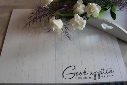 a spiral notebook with a bouquet of flowers on it at Dompanorama-Kleines Ferienloft in Havelberg