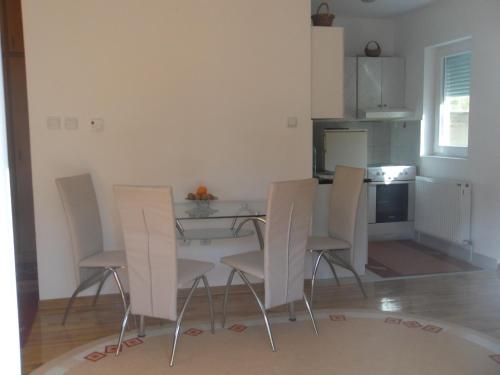 a kitchen with a table and chairs in a room at Panorama 5 in Soko Banja