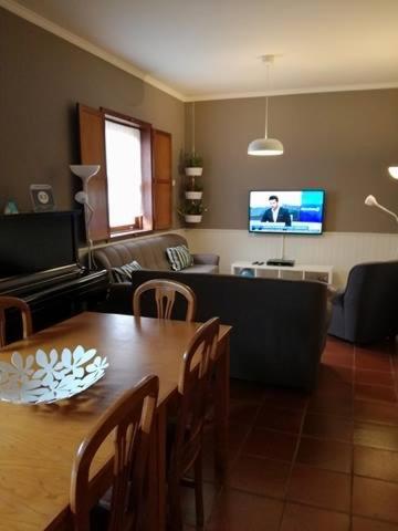 a living room with a table and a couch at Abrigo da Geira House in Campo do Gerês