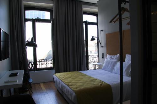 una habitación de hotel con una cama y un balcón en Porto Music Guest House, en Oporto