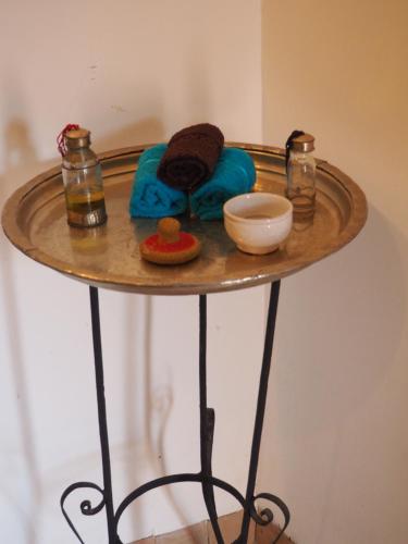 a round table with a towel and a bowl on it at Riad Ciel d'Orient in Marrakech