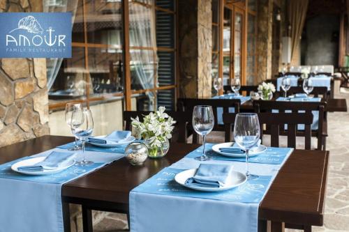 a table with a blue table cloth and wine glasses at Vik-Jan in Khmelʼnytsʼkyy
