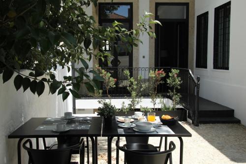 a black table and chairs in front of a house at Porto Music Guest House in Porto
