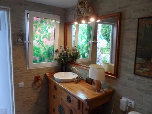 a bathroom with a sink and a mirror at Casa con jardín frente Playa de Burriana in Burriana