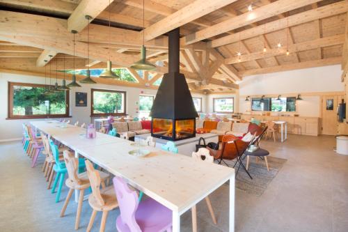 a large room with a long table and chairs at Ostello Alpino in Bormio