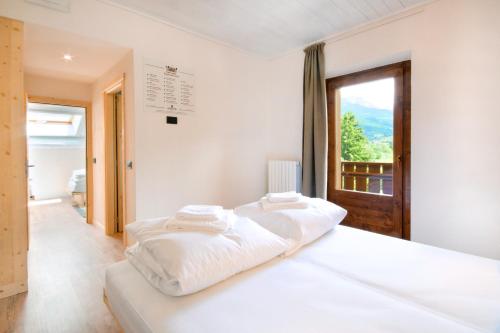 A bed or beds in a room at Ostello Alpino