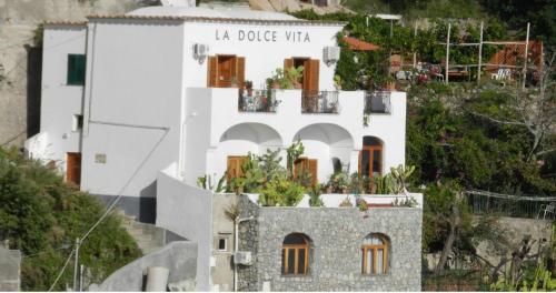 a white building with a sign on the side of it at La Dolce Vita a Positano boutique hotel in Positano