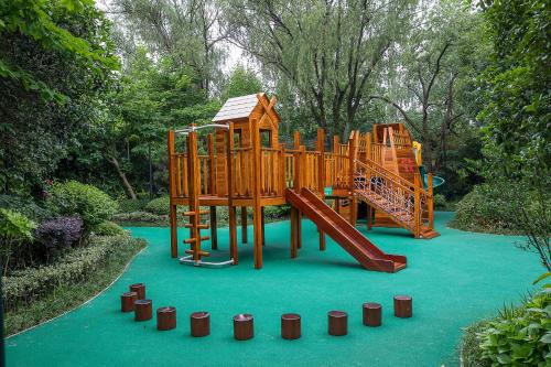 a playground with a slide in a park at Four Seasons Hotel Hangzhou at West Lake in Hangzhou