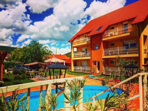 a resort with a swimming pool in front of a building at Andrea Pansio in Balatonfüred