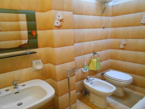 a bathroom with a toilet and a bidet and a sink at Le Chiocciole in Sannicandro di Bari