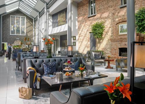 a lobby with couches and tables in a building at Lyrath Estate in Kilkenny