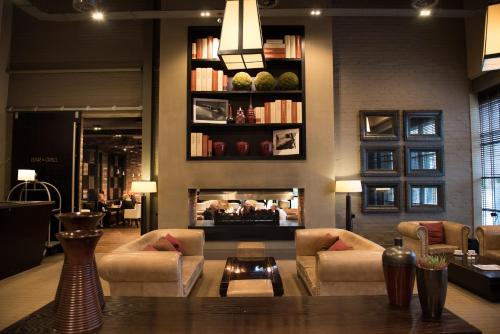 a living room with a fireplace and a table and chairs at mour hotel in Mansfield