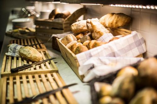 a bakery with lots of loaves of bread in baskets at Hyatt Place Gothenburg Central in Gothenburg