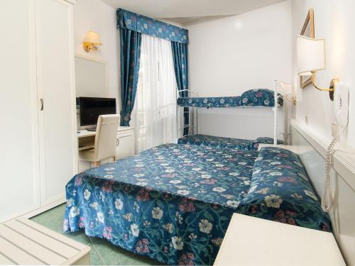 a hotel room with a bed and a desk at Hotel Nord Est in Cattolica