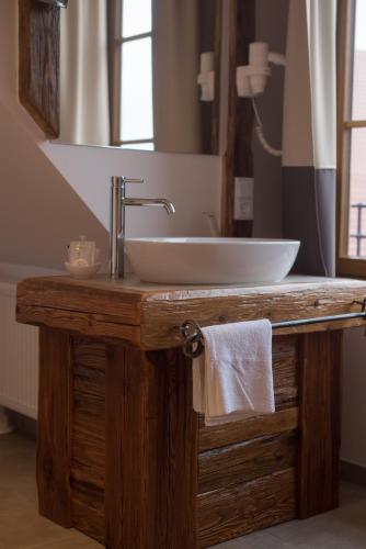 a bathroom with a sink and a mirror at Brennereihotel Sponsel in Kirchehrenbach