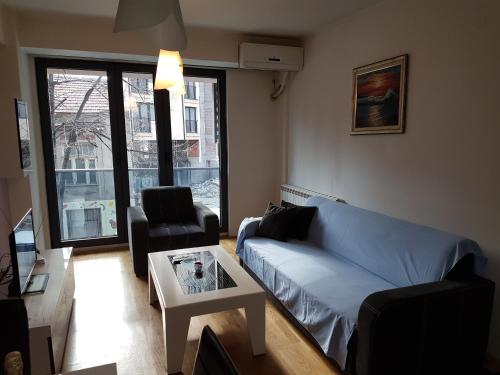 a living room with a couch and a table at Apartments Kolevski in Skopje