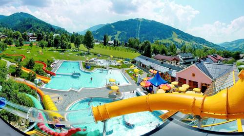 an aerial view of a water park with a water slide at Haus Hubertus in Wagrain