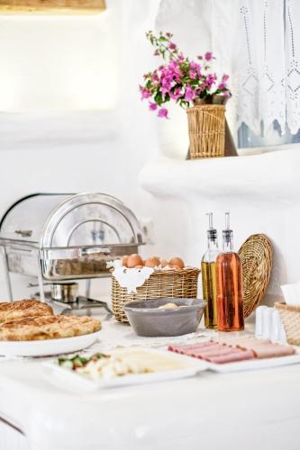 a breakfast table with bread and eggs on a counter at Orkos Beach Hotel in Mikri Vigla