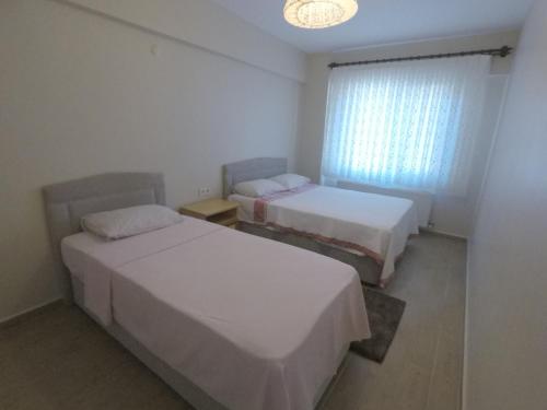 Voodi või voodid majutusasutuse Suna Apart Hotel toas