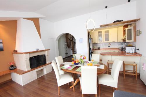 a kitchen and dining room with a table and chairs at Apartments Tanja in Rovinj