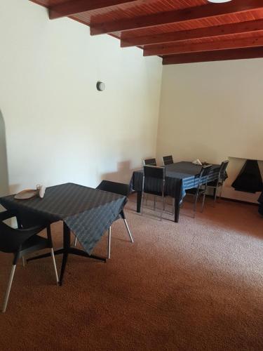 a group of tables and chairs in a room at LightStone Guesthouse in Centurion