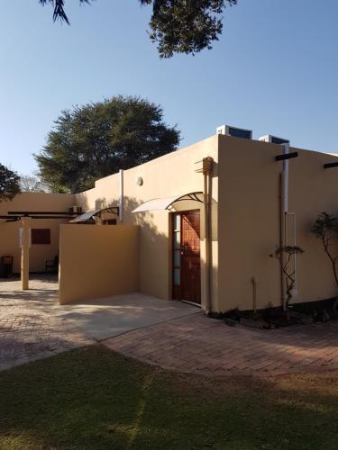 a large white building with a large door at LightStone Guesthouse in Centurion