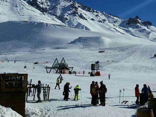 a group of people standing in the snow on a ski slope at Rodas - Las Leñas in Las Lenas