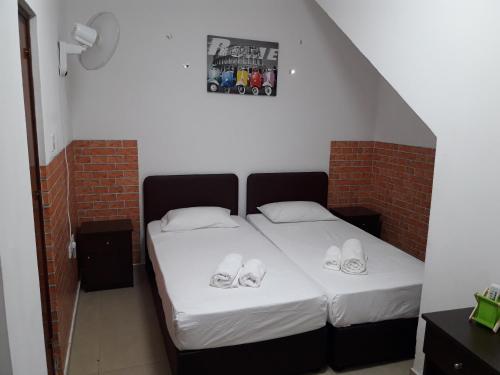 a bedroom with a bed with shoes on it at Marina's Rooms in Larnaka