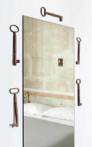 a mirror in front of a bed in a room at Napoli Bonita b&b in Naples
