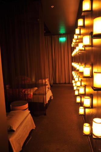 a row of beds in a room with lights on the wall at Arabella Hotel, Golf and Spa in Kleinmond