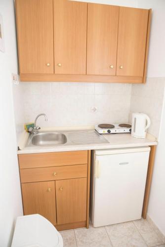 a small kitchen with a sink and a stove at Haraki View in Haraki